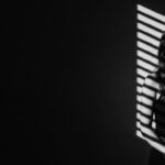 dramatic shadow portrait visual for Empty Land Between Us by Luke Ai Music symbolizing emotional distance and quiet reflection