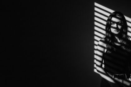 dramatic shadow portrait visual for Empty Land Between Us by Luke Ai Music symbolizing emotional distance and quiet reflection