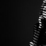 dramatic shadow portrait visual for I Fold First by Luke Ai Music representing emotional tension and quiet reflection