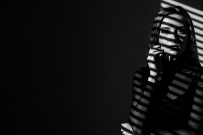 dramatic shadow portrait visual for I Fold First by Luke Ai Music representing emotional tension and quiet reflection