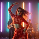 On Fire by Luke Ai Music artwork showing a confident performer dancing under colorful neon stage lights with a live band