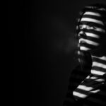 dramatic shadow portrait visual for Still Here by Luke Ai Music representing lingering memories and emotional reflection