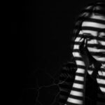 dramatic shadow portrait visual for The Lake Remembers by Luke Ai Music symbolizing hidden memories rising to the surface